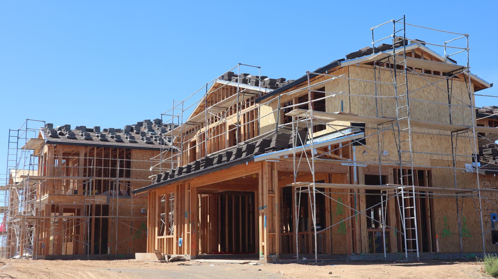 Two story homes framed and sheathed on a cleared lot