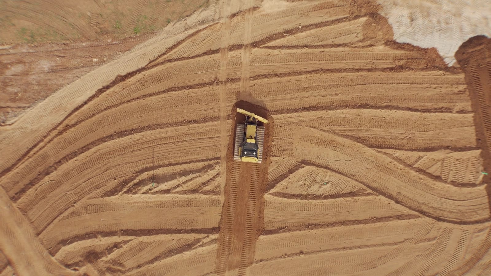Dozer grading a site, seen from directly above